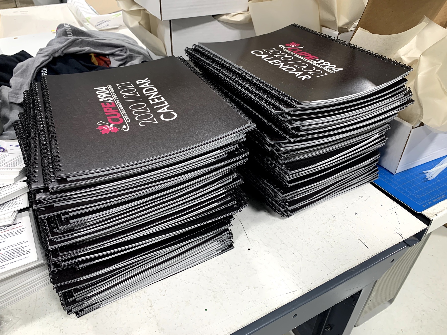 Stacks of spiral-bound union calendars